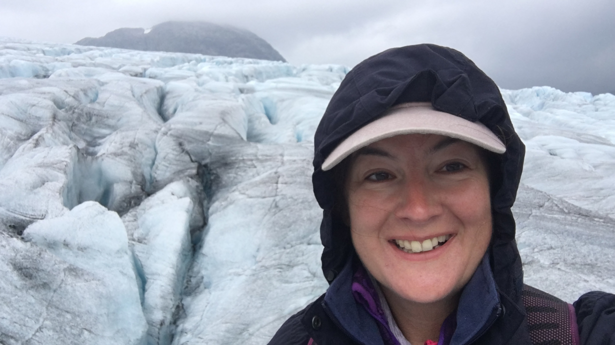 Franziska standing in front of icebergs