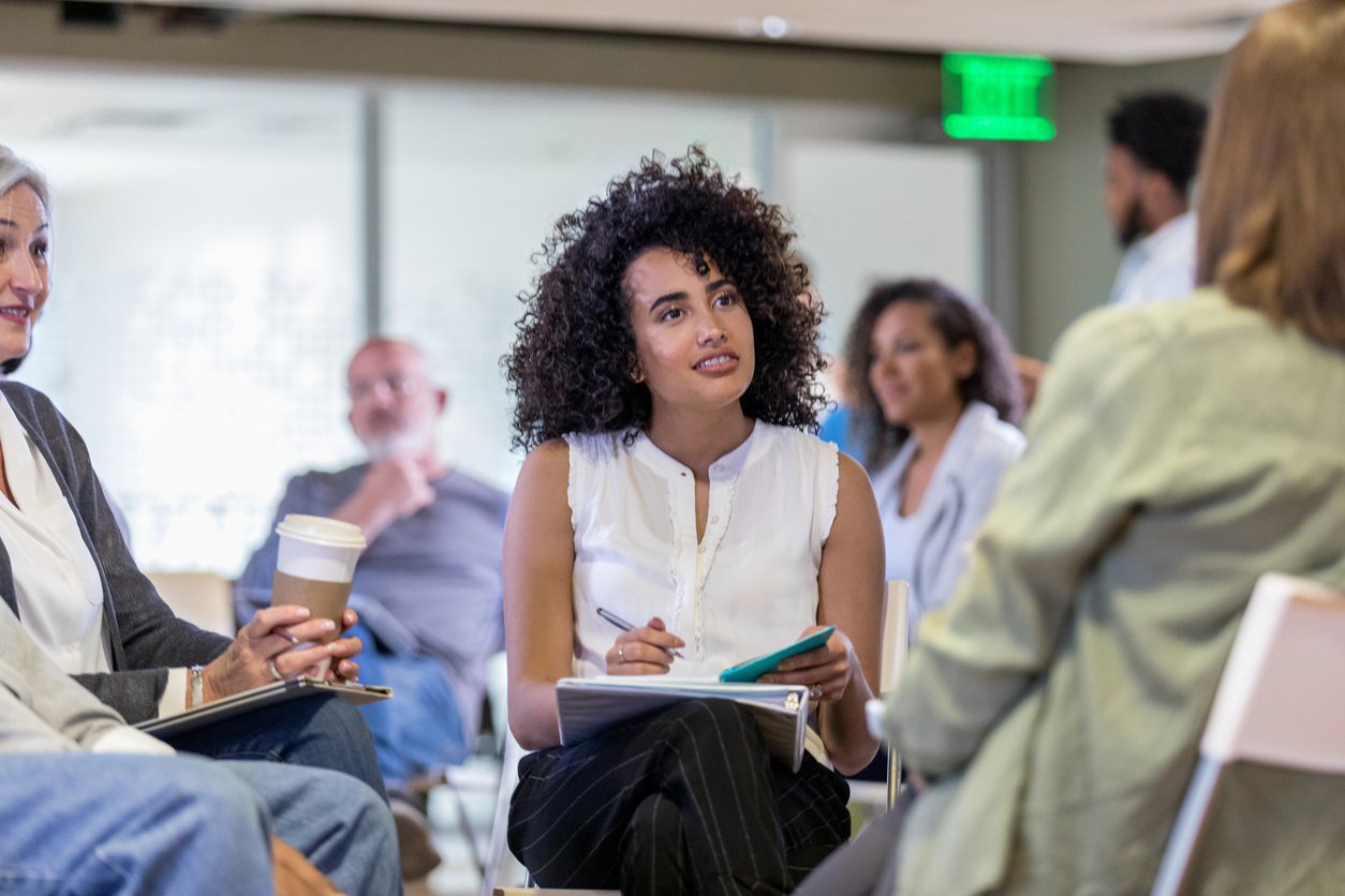 Attentive-therapist-listens-to-woman-during-support-group-meeting-1160223349_1258x838