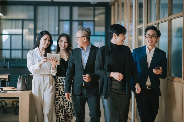 group-of-asian-chinese-successful-office-management-team-having-discussion-while-walking-toward-camera-1284346714_727x484